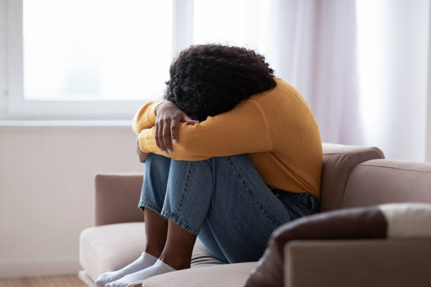 istock Young black woman with depression crying on sofa at home 1370879946
