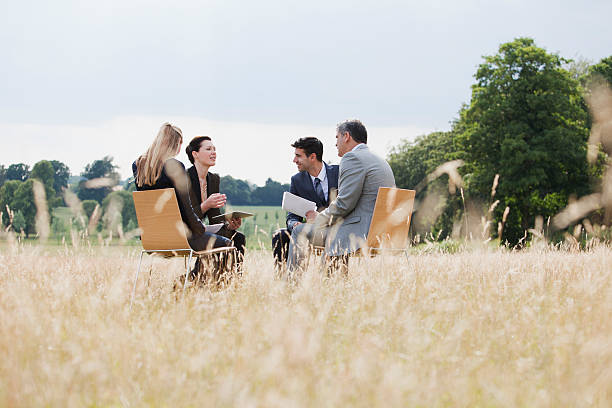 Business people having meeting outdoors  field workers stock pictures, royalty-free photos & images