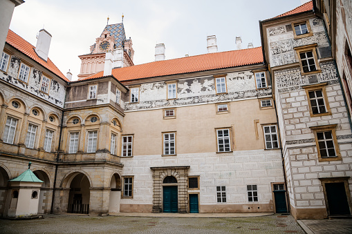 Gothic Castle Brandys nad Labem, Renaissance palace, clock tower, Historical Courtyard with sgraffito mural decorated plaster at facade, wall decor, Central Bohemian, Czech Republic, May 01, 2021
