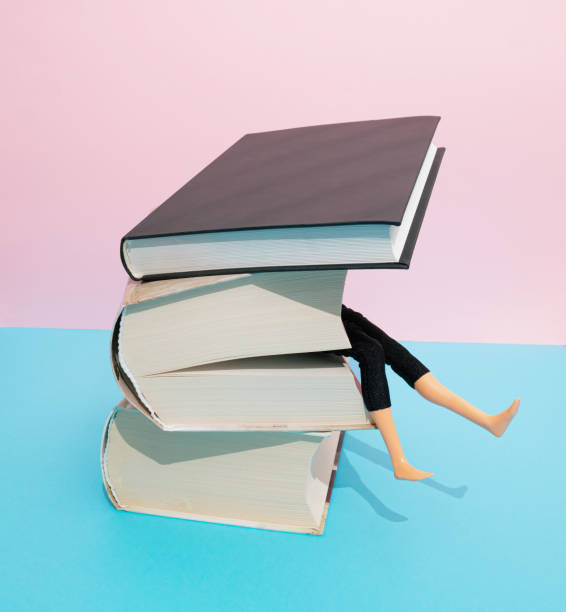 istock Heavy books crushing doll. Education, learning, studing, burnout concept. Flat lay. 1370880990