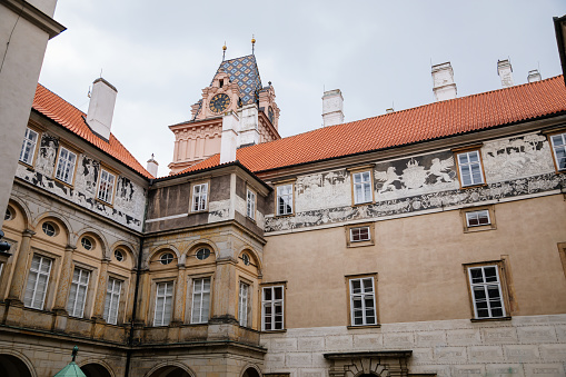 Gothic Castle Brandys nad Labem, Renaissance palace, clock tower, Historical Courtyard with sgraffito mural decorated plaster at facade, wall decor, Central Bohemian, Czech Republic, May 01, 2021