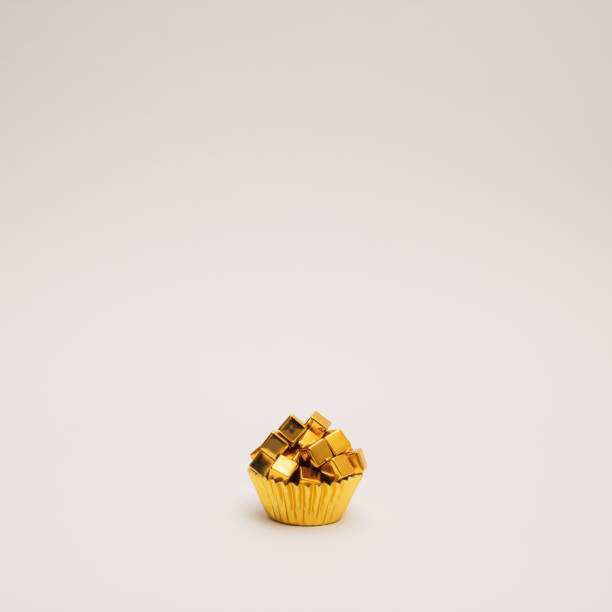 istock Golden baking cup with golden cubes on white  background. Copy space. 1370881636