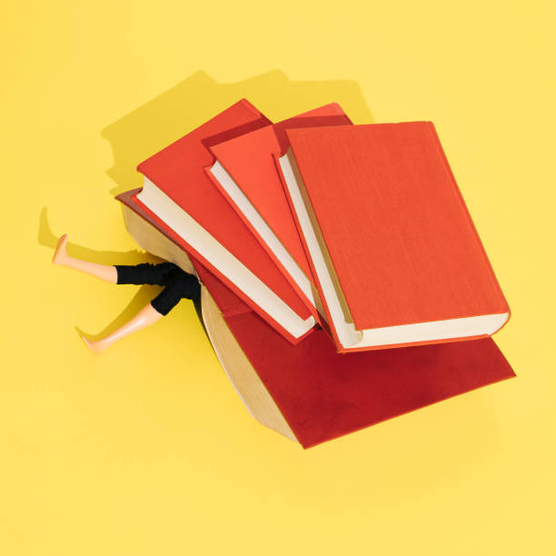 istock Heavy books crushing doll. Education, learning, studing, burnout concept. Flat lay. 1370881764
