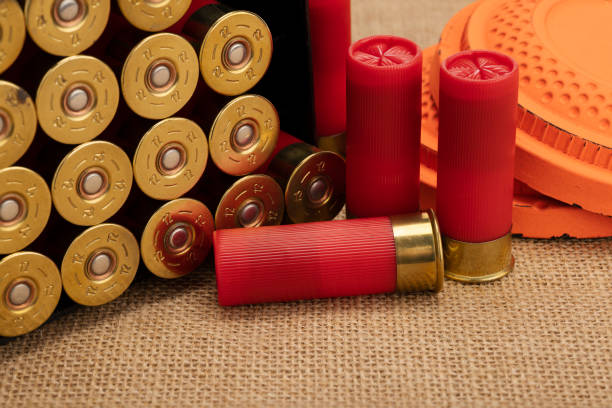 istock Clay shooting target with shotgun shell on burlap background , Shotgun game 1370882152