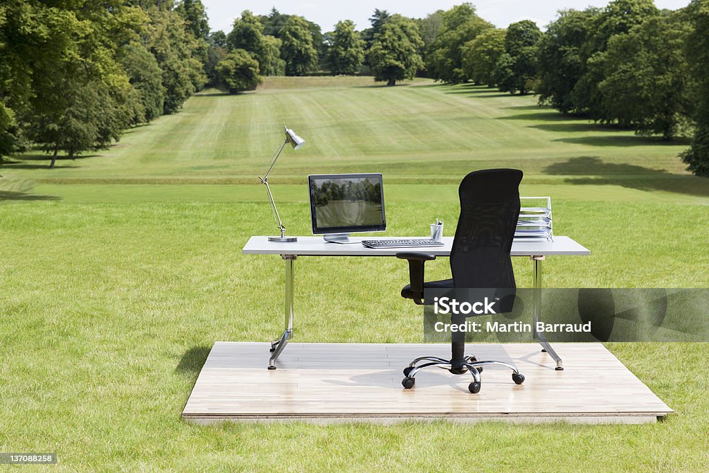 Office desk and chair outdoors in field  Desk Stock Photo