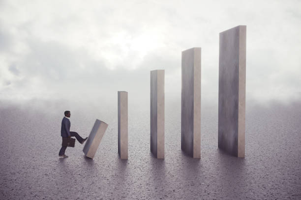 istock Black businessman kicks the first concrete domino piece 1370883318