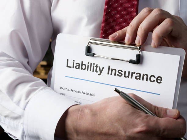 Hands hold liability insurance policy and pen. general contractors construction companies Hands hold liability insurance policy and a pen. Liability stock pictures, royalty-free photos & images