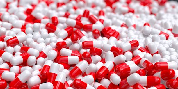 rote und weiße pharmazeutika kapseln 3d computergeneriert - computergeneriert stock-fotos und bilder