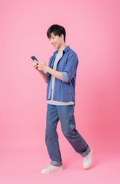 istock Young Asian man posing on pink background 1370883980
