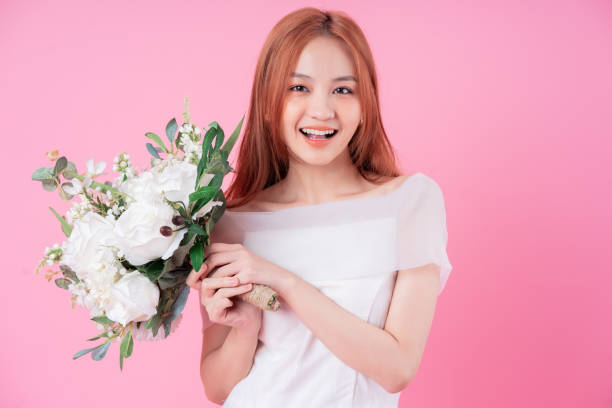 istock Young Asian bride posing on pink background 1370884017
