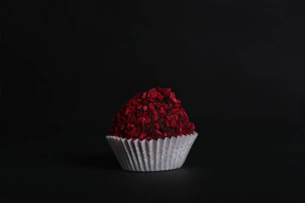 istock Chocolate candy isolated against dark background 1370885197