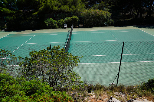 tennis court empty green floor with sport net in private house garden outdoor home