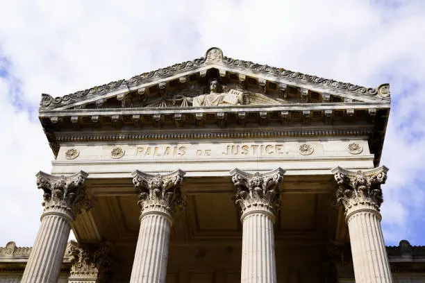 palais de justice loi french text on ancient building means in france courthouse justice court law in Perpignan city france