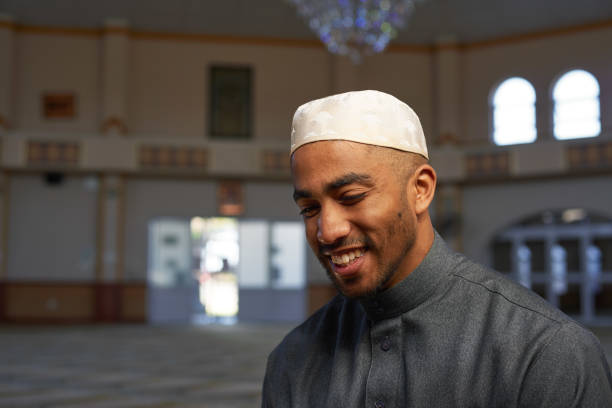 istock A young Muslim man smiles while in a mosque in the afternoon sun 1370887645