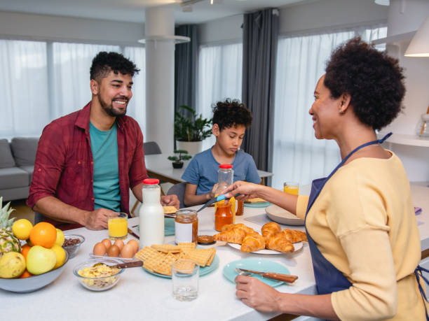 istock Happy black family having breakfast in the kitchen 1370887654