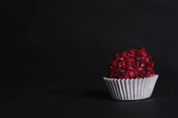 istock Chocolate candy isolated against dark background 1370888028