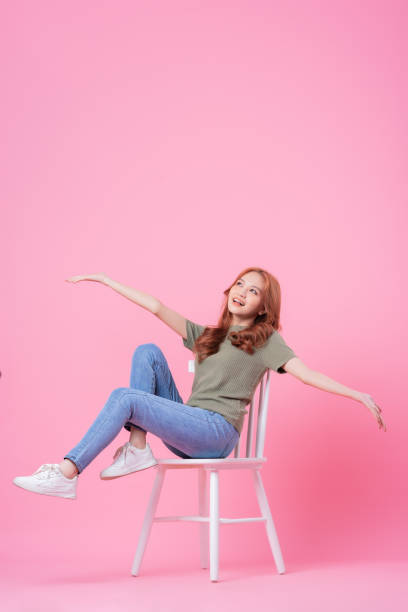 istock Young Asian woman posing on pink background 1370888056