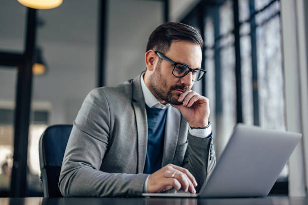 istock Concentrated caucasian businessman, focusing on his work, using laptop. 1370889184