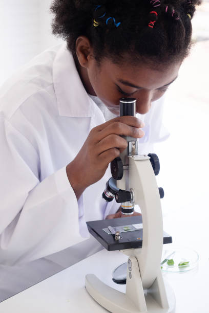 istock Young student studies small plant in elementary science class. Close-up shot in the laboratory. 1370891184
