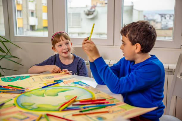 istock Caucasian siblings, coloring the flayer with a theme 