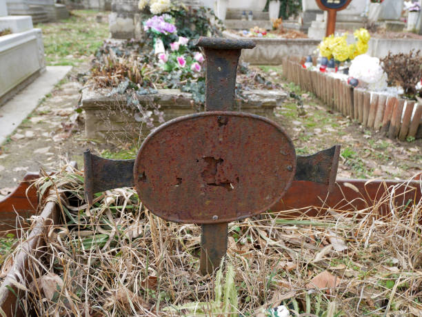 Rusty old metal tombstone in the public cemetery