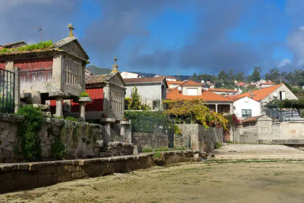 Photo of Fishing village of Combarro with the typical horreos (fish drying sheds). Galicia, Spain.