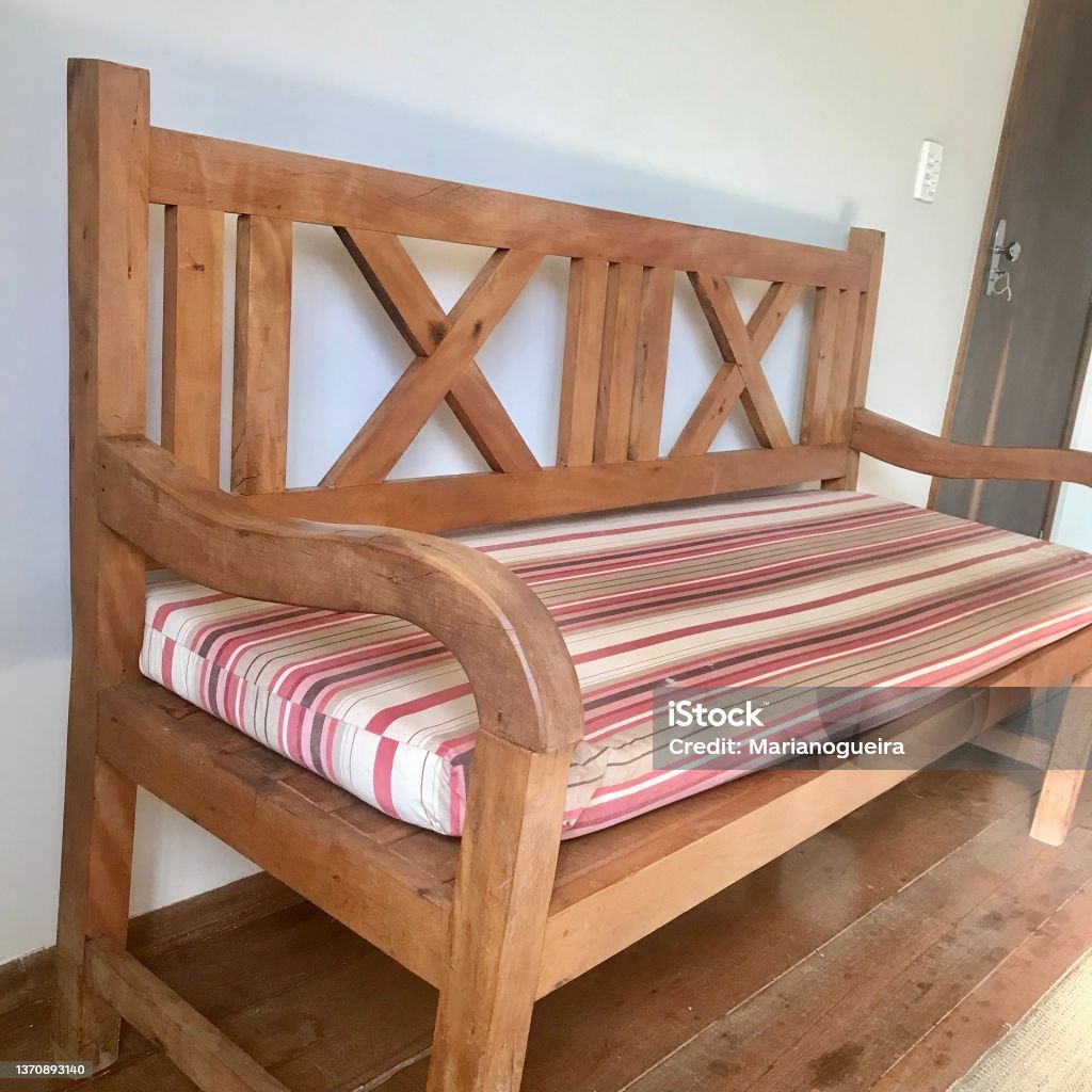 wooden bench with cushion Wooden bench with cushion Bench Stock Photo