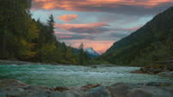 istock Scenic natural mountain river cinemagraph in the Austrian alps in Tyrol with a vibrant evening sky, close to the German border in autumn. The water is rushing along colorful fall trees. Tourist destination and vacation location. 4K UHD seamless video loop 1370897772