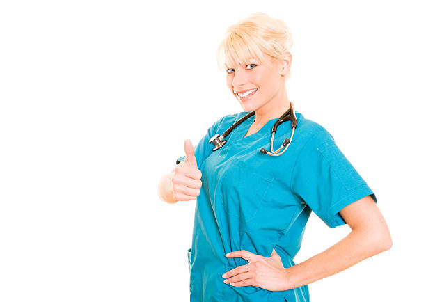 Smiling nurse giving the thumbs up isolated on white background