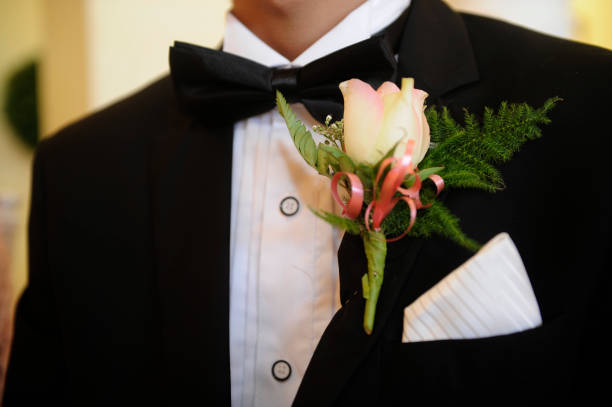 tuxedo, rose and bow tie A man wearing a tuxedo with a rose on lapel and handkerchief in top pocket tuxedo photos stock pictures, royalty-free photos & images