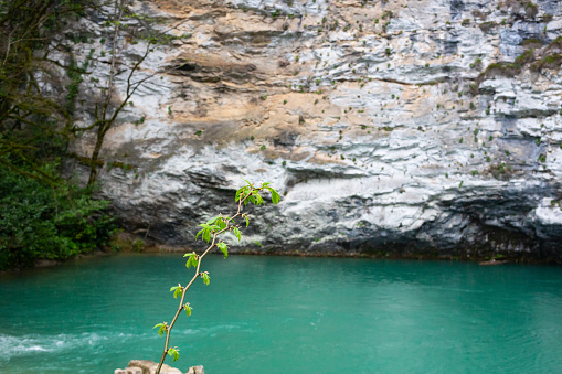 Blue lake, mountain Akhtsykh, Abkhazia, a small lake with turquoise water in the mountains, spring, April