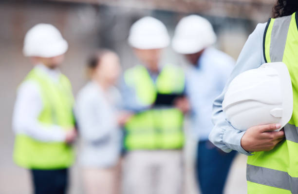 istock Shot of an unrecognizable architect holding a helmet at a building site 1370901213