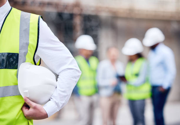 istock Shot of an unrecognizable architect holding a helmet at a building site 1370901247