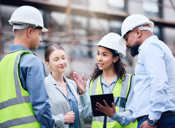 istock Shot of a group of architects using a digital tablet at a building site 1370901257