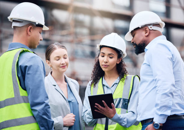 istock Shot of a group of architects using a digital tablet at a building site 1370901259