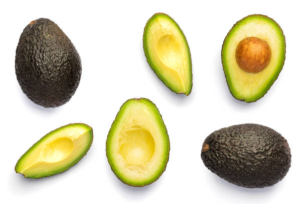 istock Whole and cut black Avocado Hass isolated on white background. 1370901295