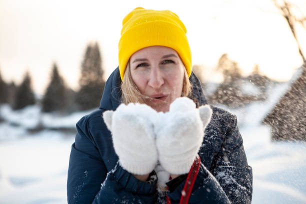 istock Woman blowing on snow 1370902478