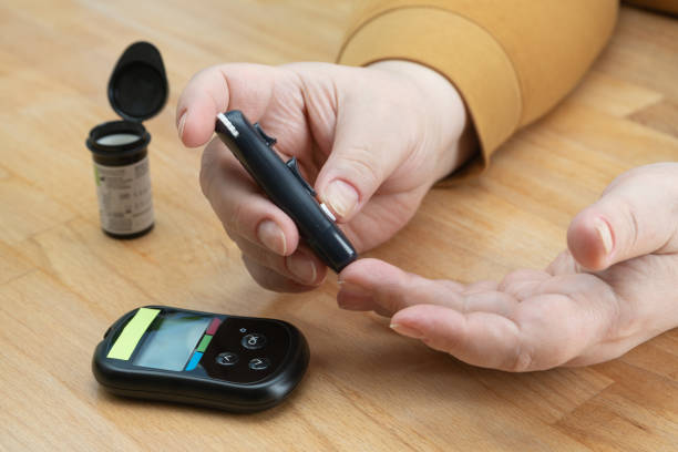 istock senior woman and diabetes tester set 1370902843