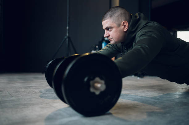 istock Man training in the gym and using dumbbells 1370904174