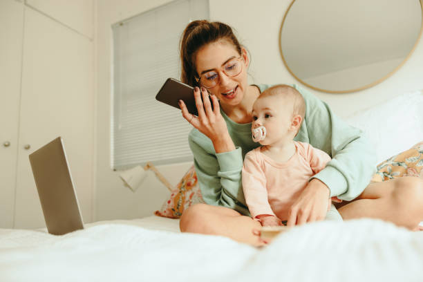 istock Multitasking mom taking a phone call while sitting with her baby 1370907996