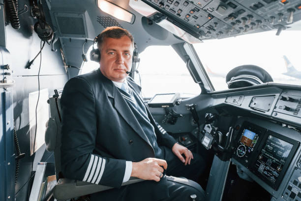 istock Side view. A professional pilot is in the cockpit. Conception of work 1370909514