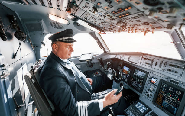istock Side view. A professional pilot is in the cockpit. Conception of work 1370909515