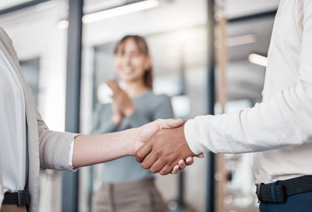 istock Shot of two unrecognizable businespeople shaking hands in an office at work 1370911569