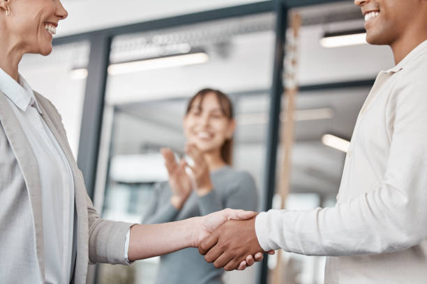 istock Shot of two unrecognizable businespeople shaking hands in an office at work 1370911570