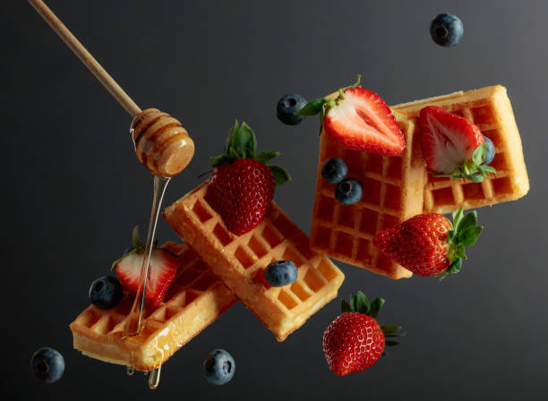 istock Waffles with blueberries, strawberries, and honey. 1370915524