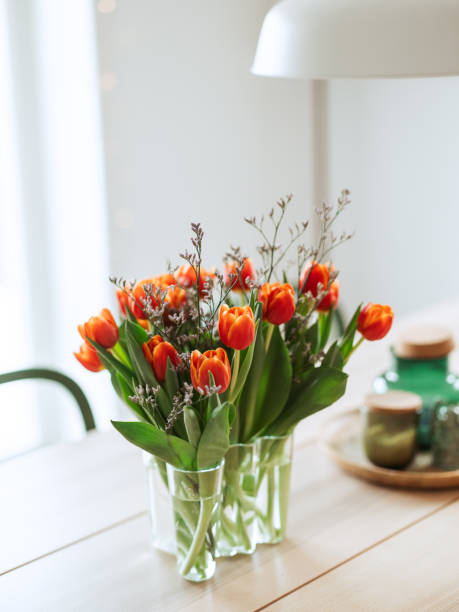 istock Red orange tulips indoors on kitchen table 1370916568