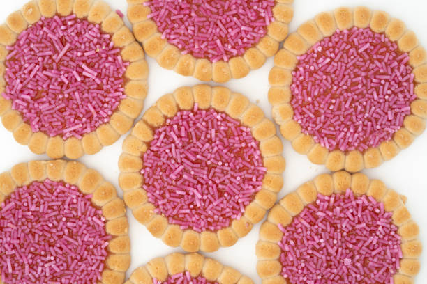 Strawberry jelly biscuits with sprinkles isolated on white background.