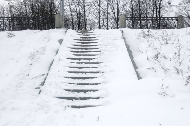 istock snow-covered steps of a granite staircase 1370919531