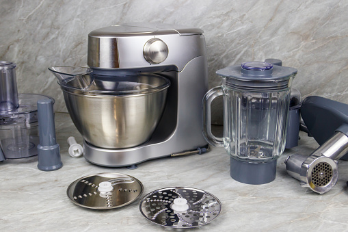 Modern kitchen machine with different attachments and accessories