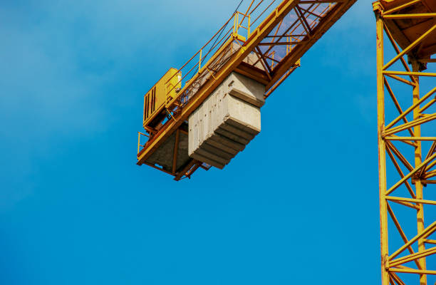 istock High-rise construction crane with a long yellow boom against the blue sky 1370919729